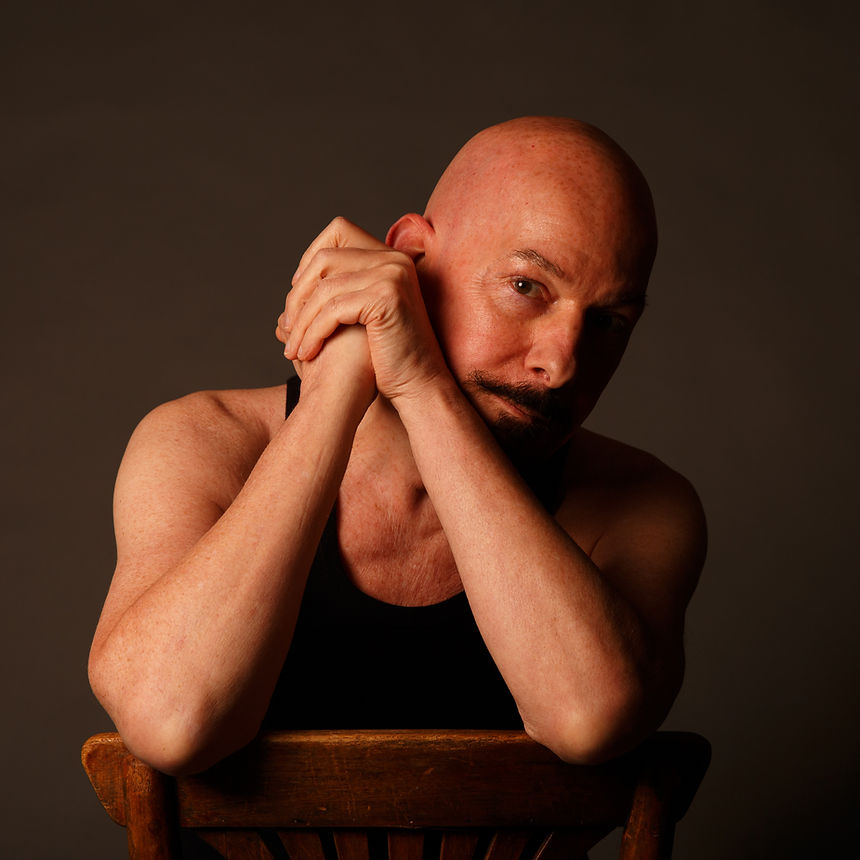 A photo of a bald man.
